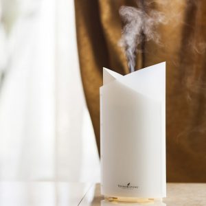 essential oil diffusing from a white diffuser