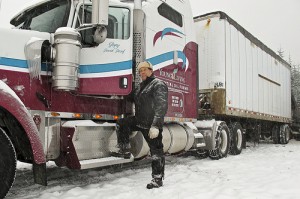 Gary Young standing next to semi truck in the snow