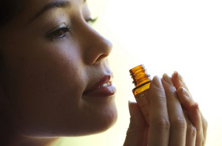 woman smelling essential oil