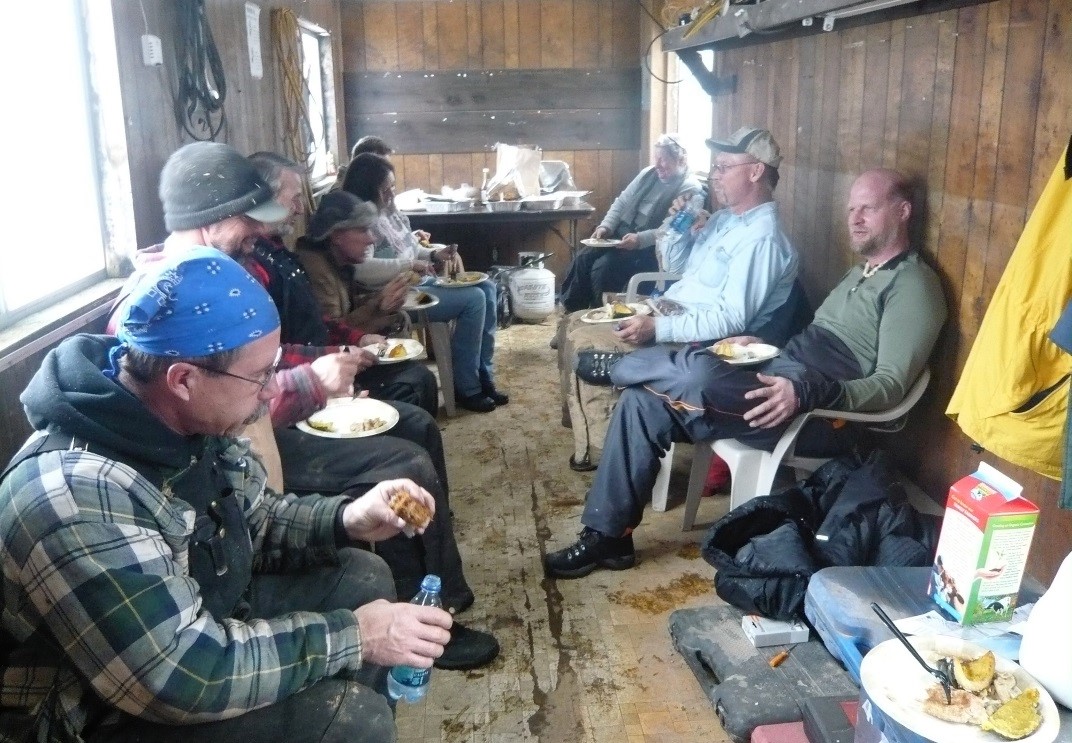 Young Living Members and crew enjoy lunch in the warming shack at Winter Harvest.