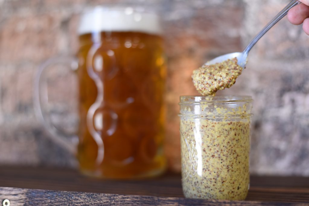 a clear, small mason jar of homemade mustard